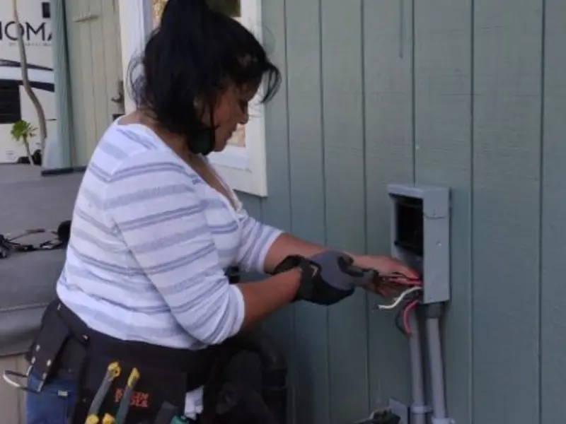 Licensed electrician wiring an exterior subpanel in Val Verde Park